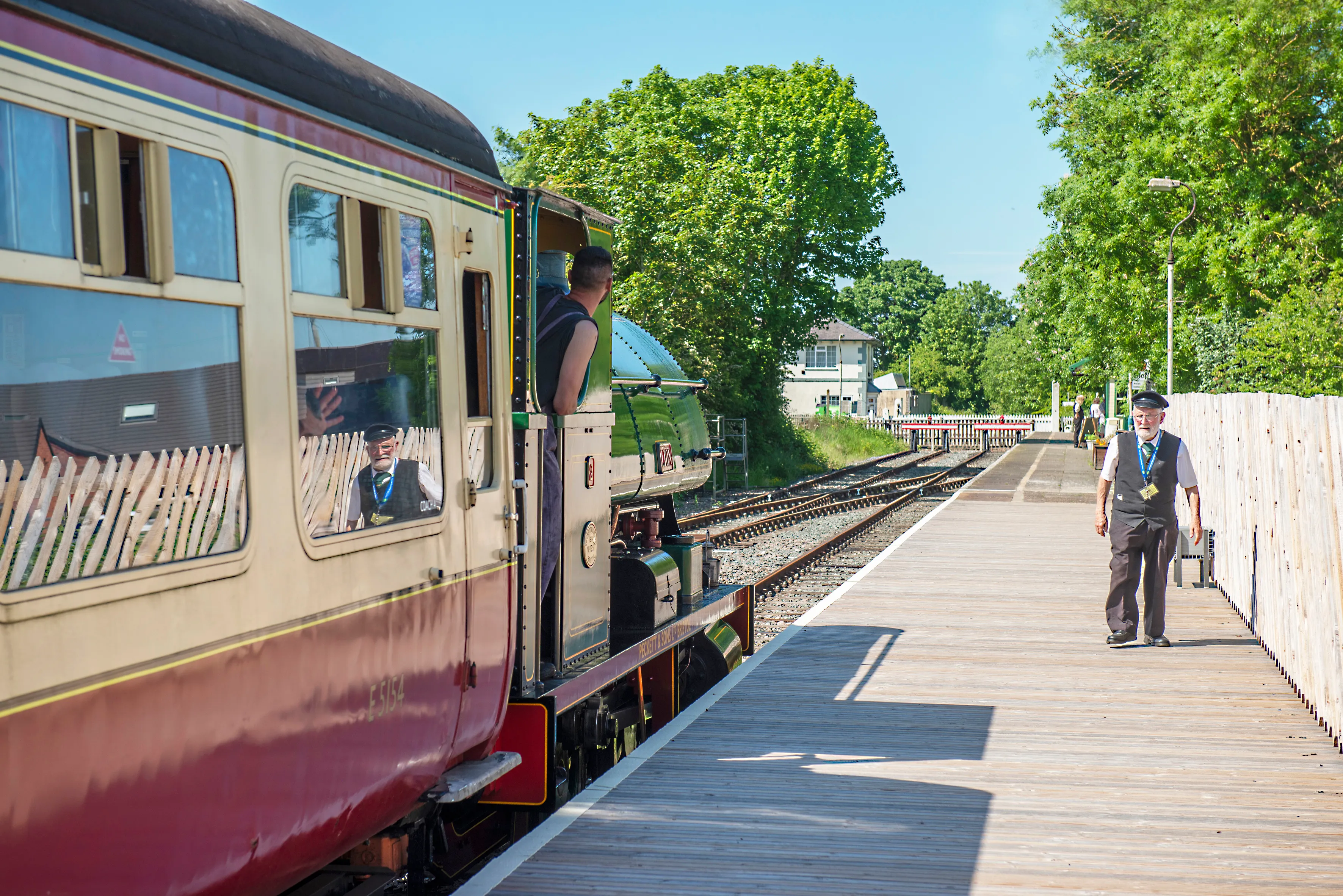 Lion, a green Peckett saddle-tank locomotive, at the head of a blood-and-custard rake at Ludborough level crossing