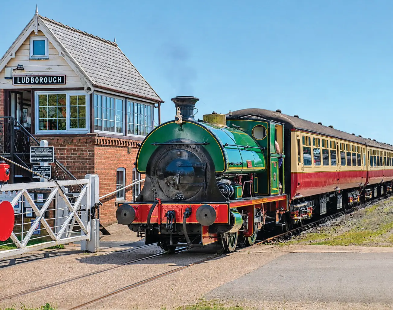 Lion, a restored green Peckett saddle-tank locomotive, passing Ludborough signal box