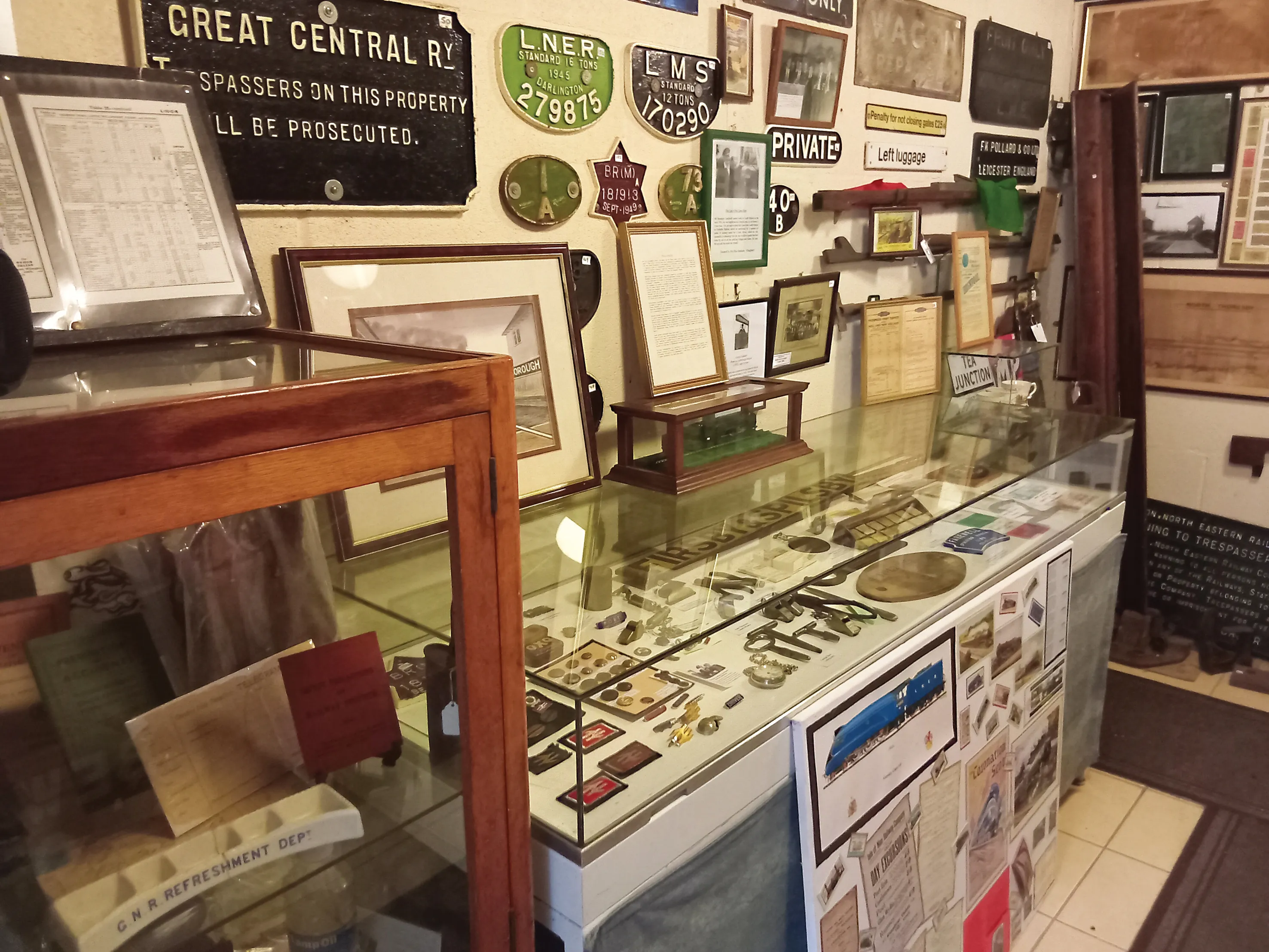 Display cases and cast-iron railway signs in the museum at Ludborough Station